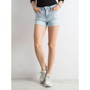 Blue denim shorts with rolled-up legs
