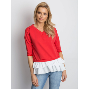 A blouse with 3/4 sleeves and a red frill