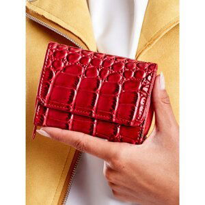 A red women's wallet with an embossed animal motif
