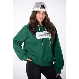 oversize sweatshirt with a hood and a badge