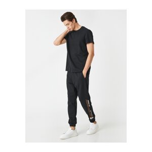 Koton Jogger Sweatpants with a skull print, pockets and a lace-up waist.