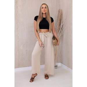 Beige trousers with a wide waist